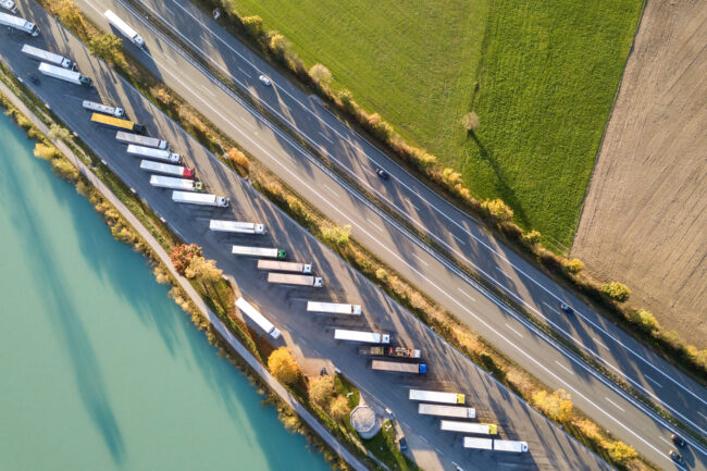 Top down aerial view of highway interstate road with fast moving supply chain - flexible haulage partnership